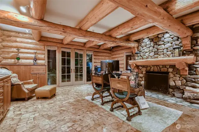 Owner's retreat with beautiful inlaid wood flooring and river rock fireplace.