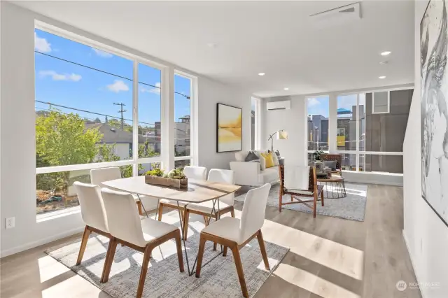 Bask in the natural light that floods this open-concept living and dining area, ideal for both relaxation and entertaining.