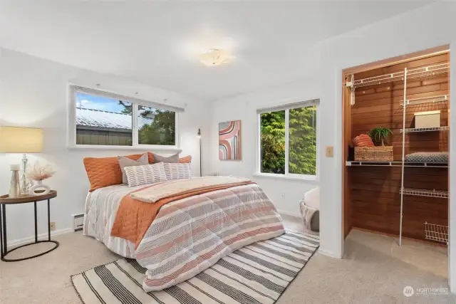 This bedroom is a peaceful and inviting space, with natural light pouring in through the window, creating a bright and airy atmosphere.