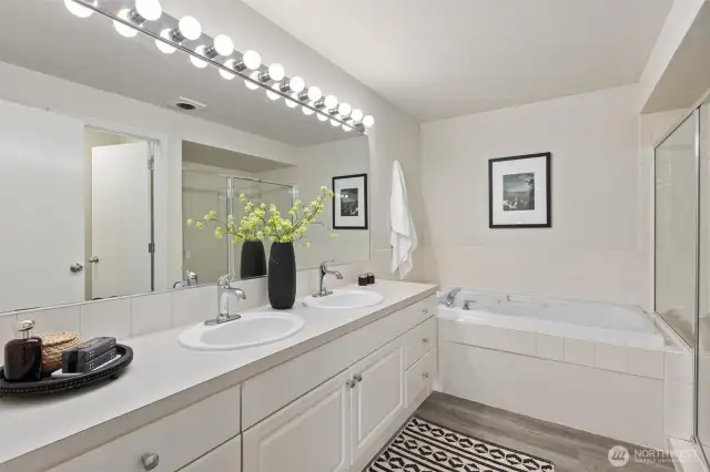 2 sinks, plenty of space. To the right is a separate toilet room with door.
