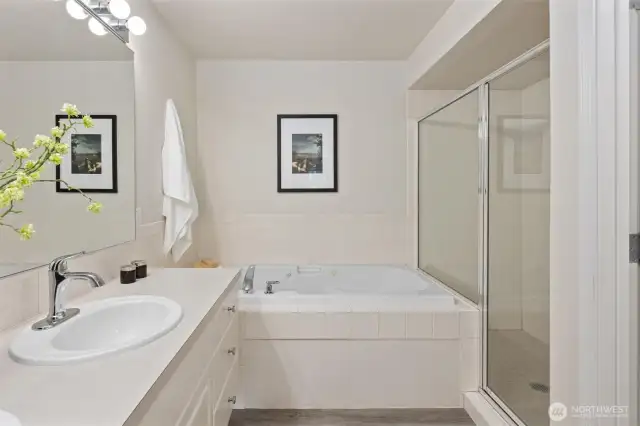 2 sinks, plenty of space. To the right is a separate toilet room with door.