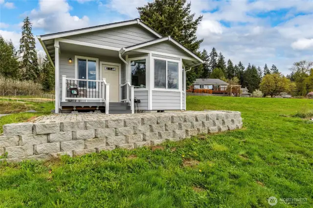 A covered front porch offers a peaceful spot to relax and enjoy the views.