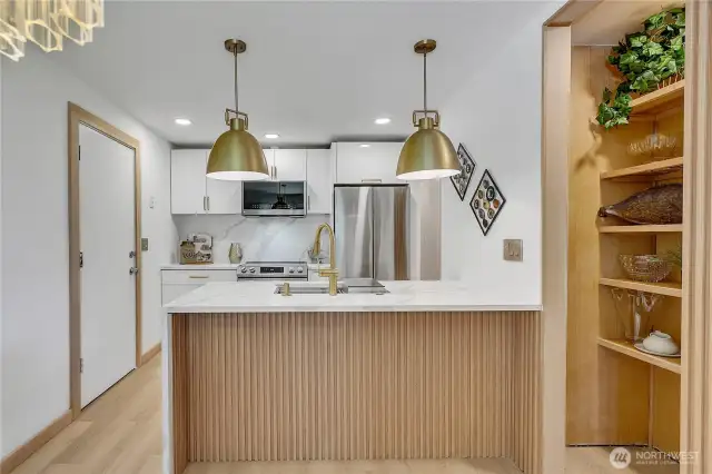 The light fixtures are oversized brass and crystal in the dining room...