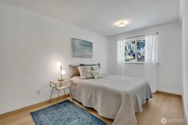 Larger bedroom at the rear of the home with custom interior wood door and glass doorknobs!