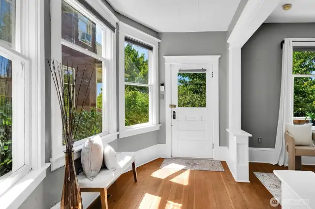 Gorgeous fir floors, high ceilings, windows galore, and beautiful period details can be found throughout the entry, living, and dining.