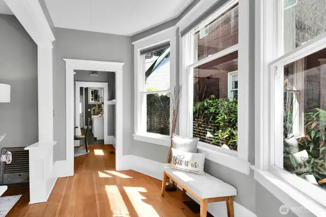 Gorgeous fir floors, high ceilings, windows galore, and beautiful period details can be found throughout the entry, living, and dining.