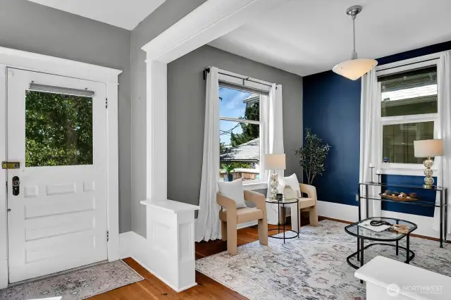 Gorgeous fir floors, high ceilings, windows galore, and beautiful period details can be found throughout the entry, living, and dining.