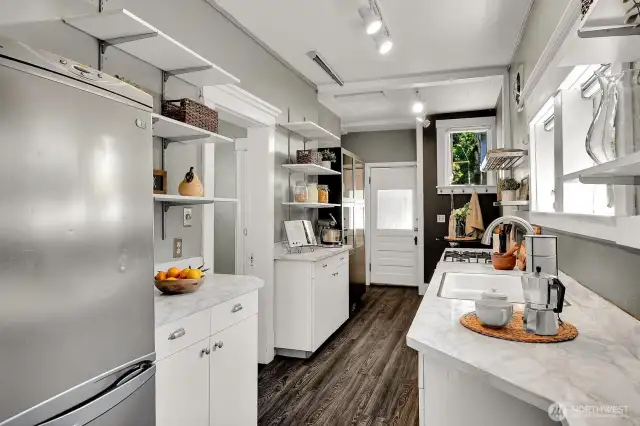 This eat-in kitchen is packed with storage and counter space. Back door leads to the sweet brick patio.