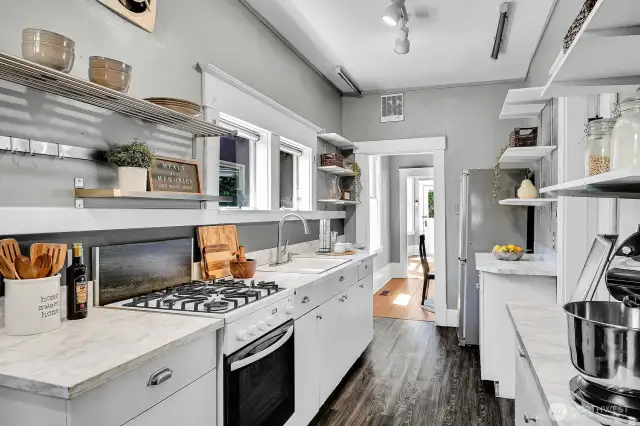This eat-in kitchen is packed with storage and counter space. Back door leads to the sweet brick patio.