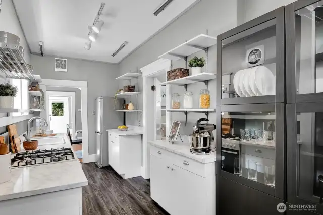 This eat-in kitchen is packed with storage and counter space. Back door leads to the sweet brick patio.