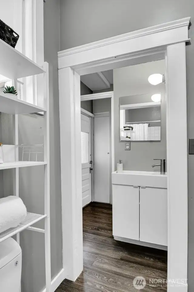 Continental full bath with lots of storage.