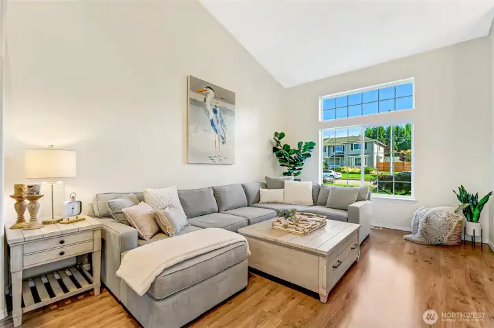 spacious living room with tall vaulted ceiling