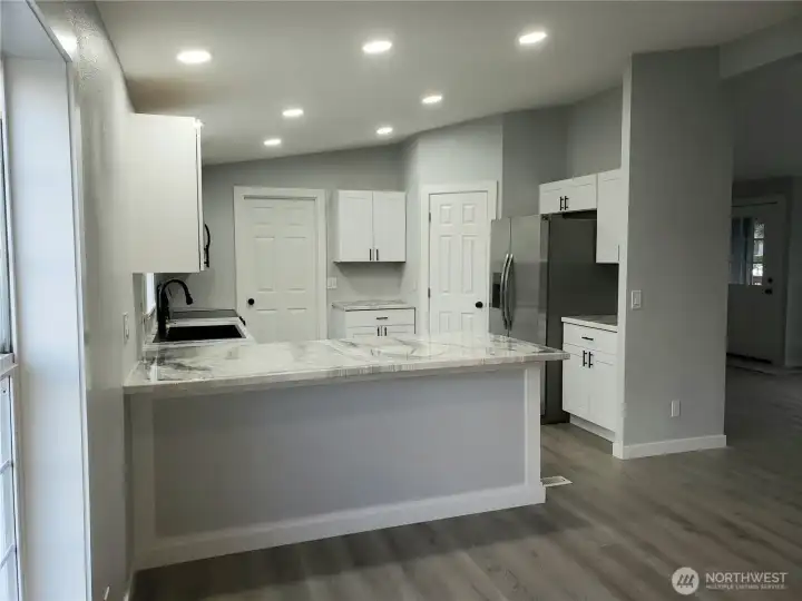 Very Spacious All New Kitchen with New White Cabinets, Counter Tops with Breakfast Eating Bar Walk In Pantry, Stainless Appliances Including Microwave, New Paint, Sink, Faucet, Recessed LED Lighting, Trim and Vinyl Plank Flooring.
