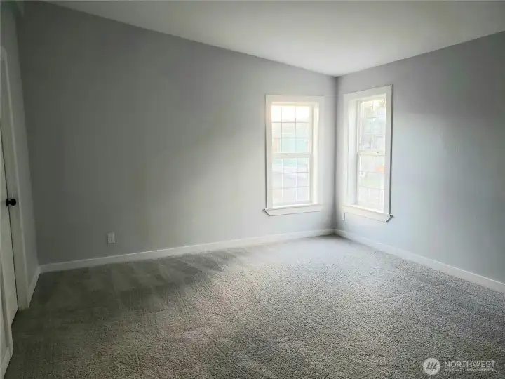 A Different View of the Primary Master Bedroom Showing Cathedral Ceilings, All New Paint, Trim and Carpeting.