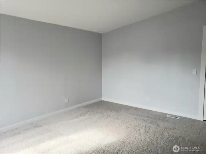 Another View of the Primary Master Bedroom Showing Cathedral Ceilings, All New Paint, Trim and Carpeting.