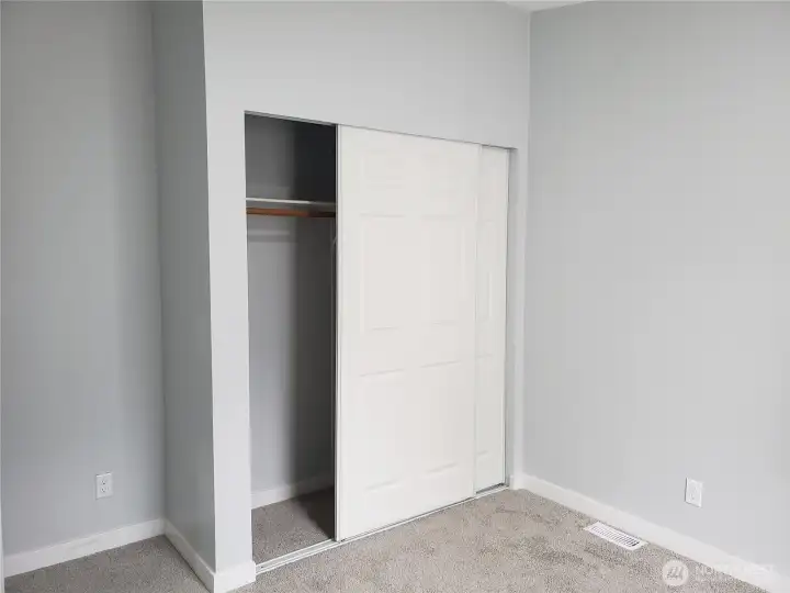 Another Picture of the Spacious Second Bedroom with New Paint, Trim and Carpeting Showing Large Closet.