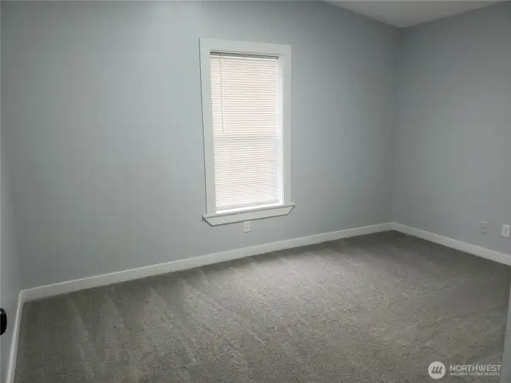 Picture of the Spacious Third Bedroom with New Paint, Trim and Carpeting.