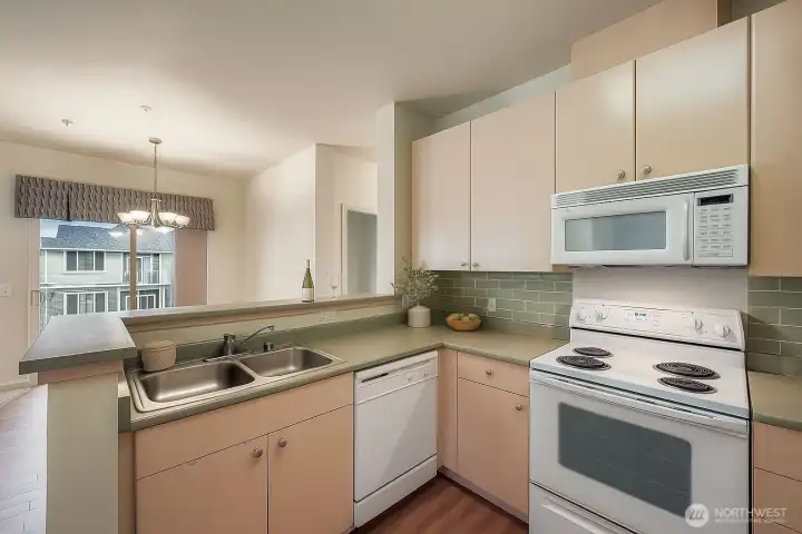 Virtual: Bright and functional kitchen featuring ample cabinet space and an open layout perfect for everyday living.