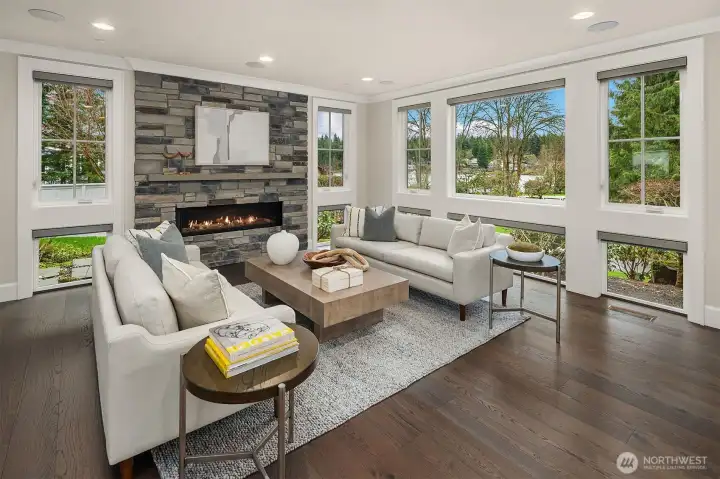 You’ll be surrounded by light in this living room.  All windows have custom electric blinds, so be prepared to enjoy views of Lake Washington from your favorite sofa.