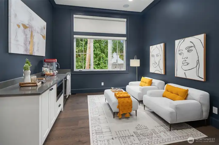 The second floor features a dedicated theater and entertainment room designed for comfort and convenience. This room is equipped with a built-in refrigerator and microwave, making it easy to enjoy refreshments and snacks without having to leave the area.