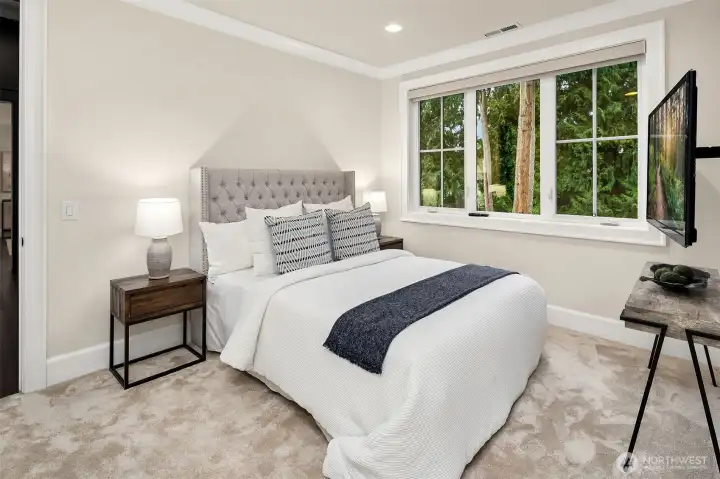 Guest bedroom with attached tv has a walk-in closet and en-suite bathroom.