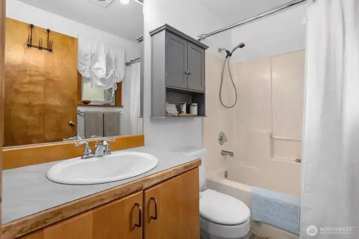 Spacious bathroom with wide vanity, ample counter space, and bright overhead lighting.
