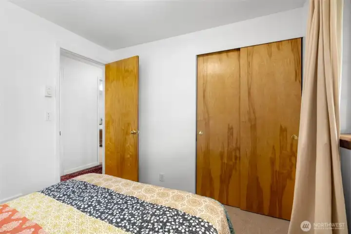 Second bedroom featuring sliding closet doors and flexible furniture placement.