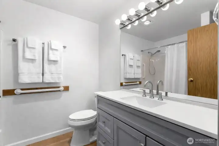 Clean and functional full bathroom with tub/shower combination, updated vanity, and neutral finishes.