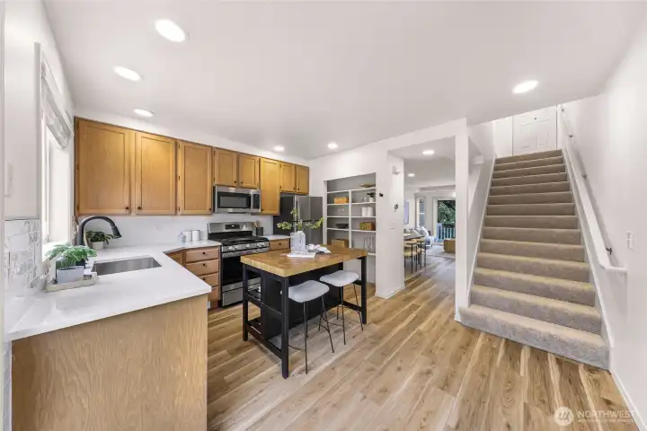 Spacious kitchen with butcher block island.