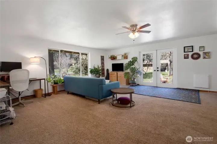Large family with french doors that lead to a tranquil river rock patio