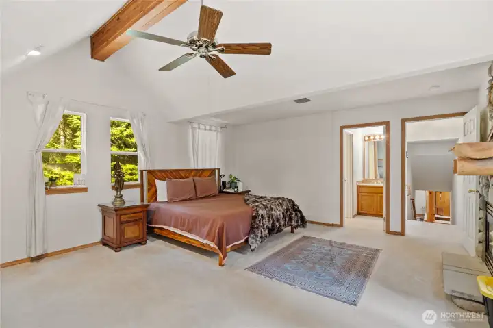 Primary suite features vaulted ceilings, gas fireplace and attached bathroom.