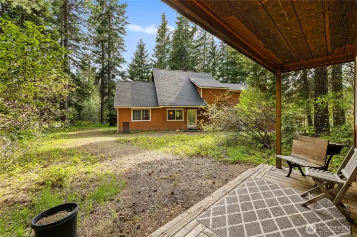 Guest cabin offers a private covered porch.