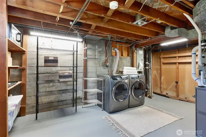 Lower laundry offers storage and space for hobbies.
