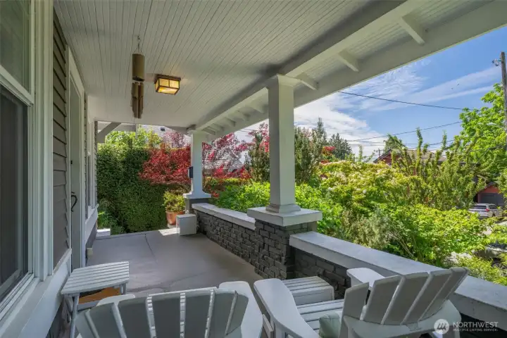 The broad overhang provides space for year round enjoyment. Perched up off the street and surrounded by lush plantings for peace and privacy