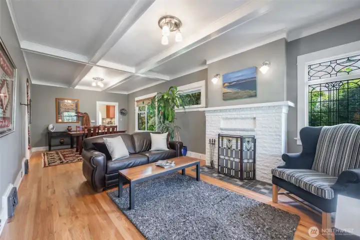 Open and bright main living area with newly refinished oak hardwoods and adorned with period stained glass window