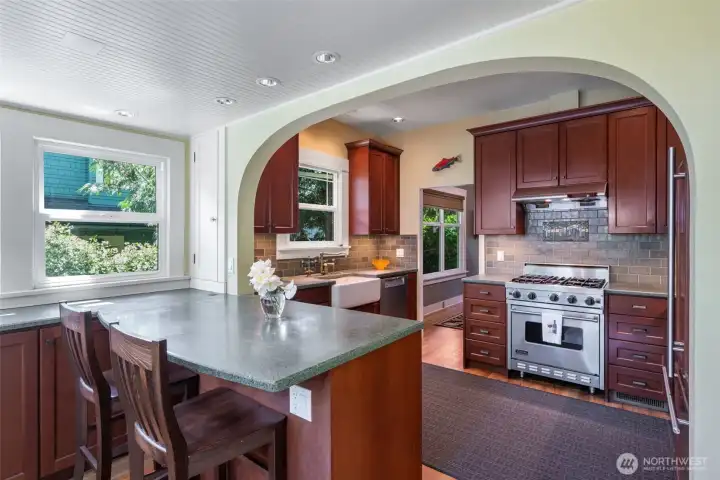 Exquisite kitchen remodel features custom Brazilian cherry cabinetry and professional grade appliances