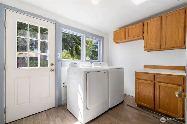 Toward the rear of the home, and located off of the kitchen, is the mudroom and laundry room.  Love all the built in storage.