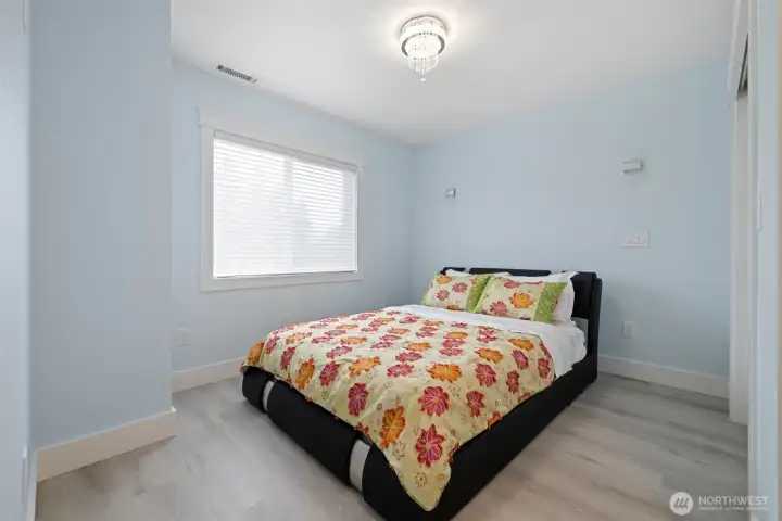 One of two main floor bedrooms, note the new flooring.