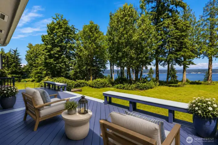 Virtually staged. Enjoy the best PNW sunrises from your expansive deck and large lot. This home is built for entertaining or retreating to your Island oasis.