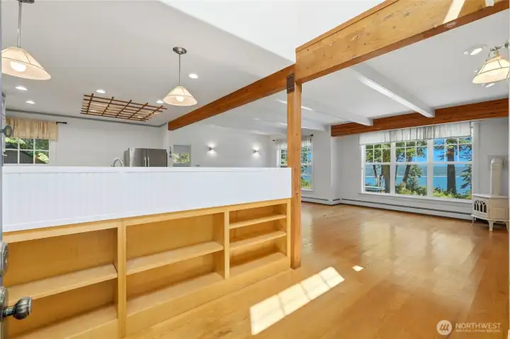 Welcoming entryway leading to the sun-filled living room and kitchen, complete with charming built-in shelving.