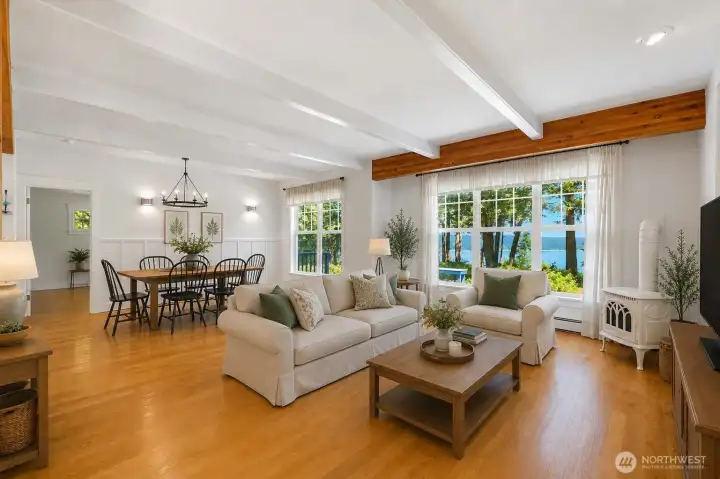 Virtually staged. Create the living room of your dreams, where expansive windows frame stunning waterfront views, a charming gas fireplace adds warmth and character, and the open-concept layout is perfect for everyday living and entertaining.