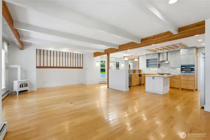 Bright and inviting great room with exposed wood beams and a spacious kitchen with island seating.