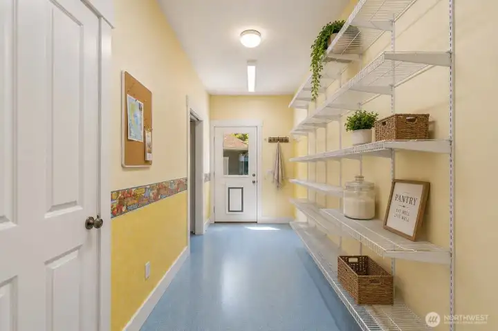 Virtually staged. Spacious pantry with abundant shelving, additional storage closet, and convenient access to the detached garage.