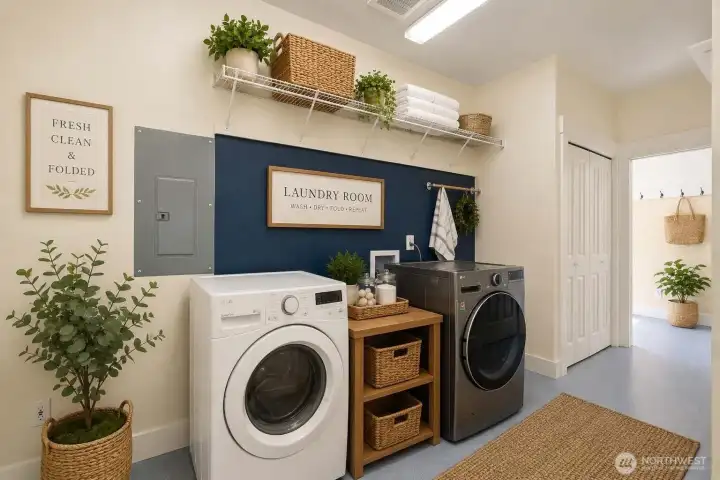 Virtually staged. Functional laundry room offering a built-in ironing board, washer and dryer, shelving, and extra closet storage.