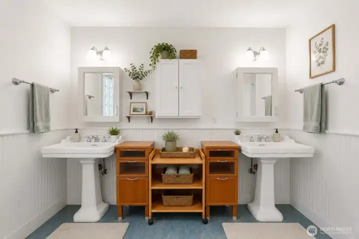 Virtually staged. Well-appointed bathroom featuring dual sinks, additional cabinet storage, and easy step-in shower.