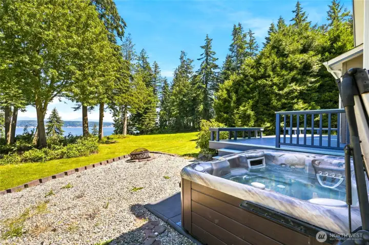 Unwind in the hot tub, gather around the fire pit, and enjoy the serene water and mountain views from your nearly 3-acre retreat.