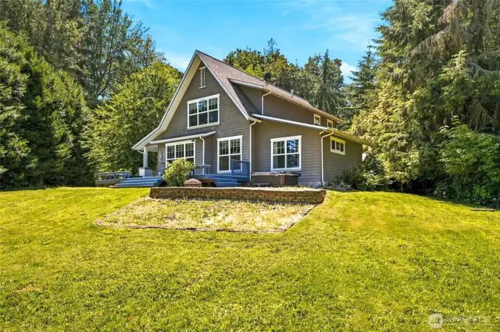Enjoy the best of island living with a large yard, private setting, expansive outdoor living space, and hot tub surrounded by nature.