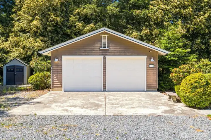 Spacious detached two-car garage plus three additional storage sheds, providing abundant space for vehicles, tools, outdoor equipment, and hobbies.