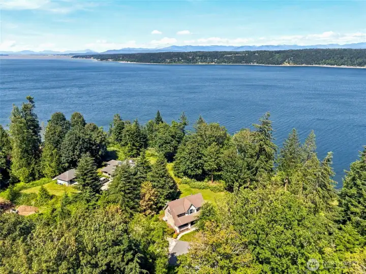 Nearly 3 private acres, breathtaking water and mountain views, and the exceptional privacy created by mature trees surrounding the property. Perched above the shoreline with 132 feet of waterfront and tideland rights, this is Pacific Northwest island living at its finest.