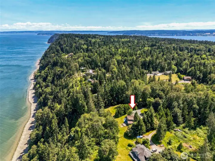 Perched high on the bluff with 132 feet of waterfront and tideland rights, this peaceful retreat offers exceptional privacy while remaining connected to the beauty of the Puget Sound.